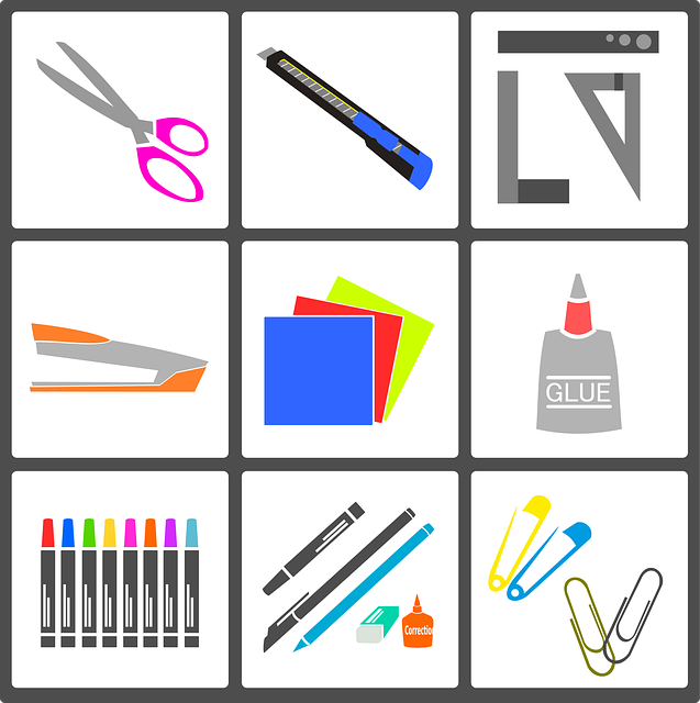 A Box divided into 9 smaller boxes each displaying a craft tool. Top left scissors, top center a pen, top right rulers and measuring tools, middle left a stapler, middle center colored paper, middle right a glue bottle, bottom left markers, bottom center paint bushes, bottom right paper clips. 