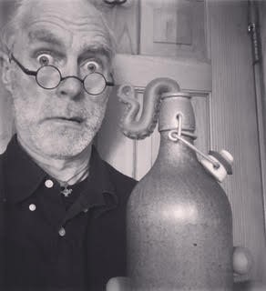 Waterbury magician CJ May next to a magic contraption.