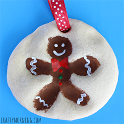 Paper Christmas ornament with a painting of a ginger breadman.  
