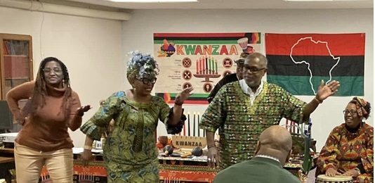 People in front of a room dancing and celebrating African culture.